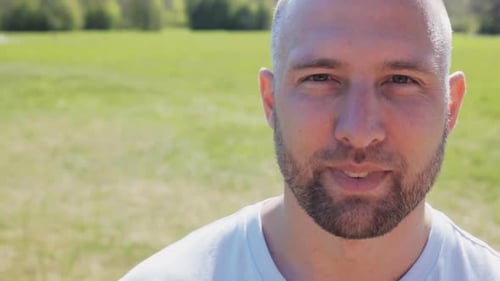 Smiling Man Face Close Up in Green Field