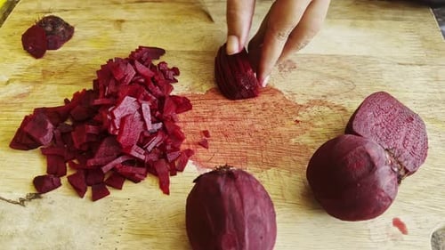 Chopping Fresh Raw beetroot Close-Up on wood board Background studio shot