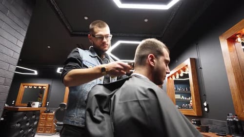 Barber Giving Haircut in Modern Barbershop
