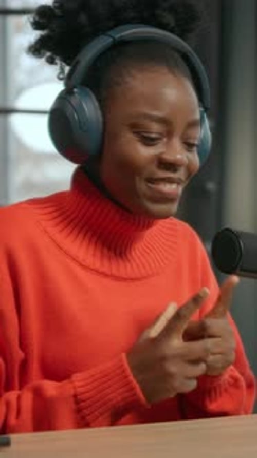 Female Vocalist Recording Animated Woman Delivering Vocal Performance in Professional Recording