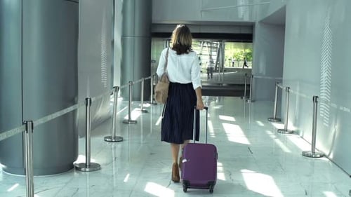 Businesswoman With Luggage Walking Through Hall At Hotel, Super Slow Motion 240fps