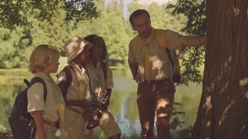 Scout Leader Showing Kids Around Forest Flora
