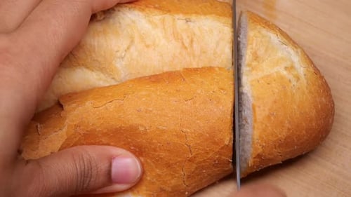 Slicing a Fresh Loaf of Bread with Knife