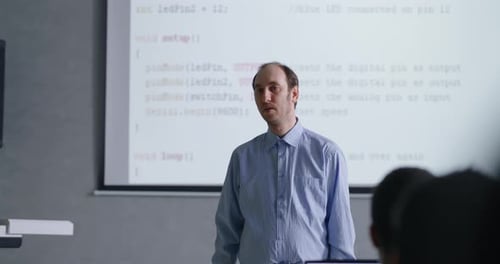 Programming Classes For Students And Schoolchildren Male Teacher Speaking In Classroom