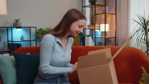 Woman Opens Delivery Box with Happy Reaction