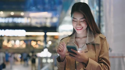 Happy Smiling Businesswoman After Work in Evening Standing Outside and Scrolling Through Work Chats