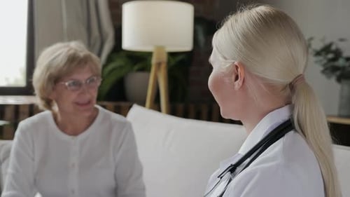 Doctor and Patient in Living Room Discussing Health