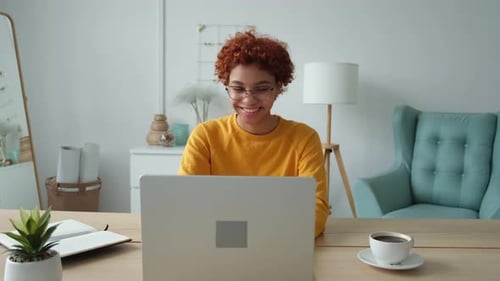 African American Girl Using Laptop at Home Office Looking at Screen Typing Chatting Reading Writing