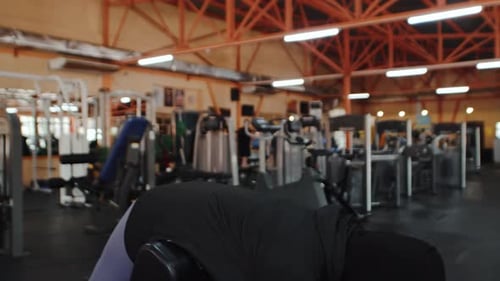 Woman Working Out at Gym on Weight Machine