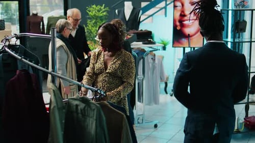 Woman Shopping for Clothes in Stylish Boutique
