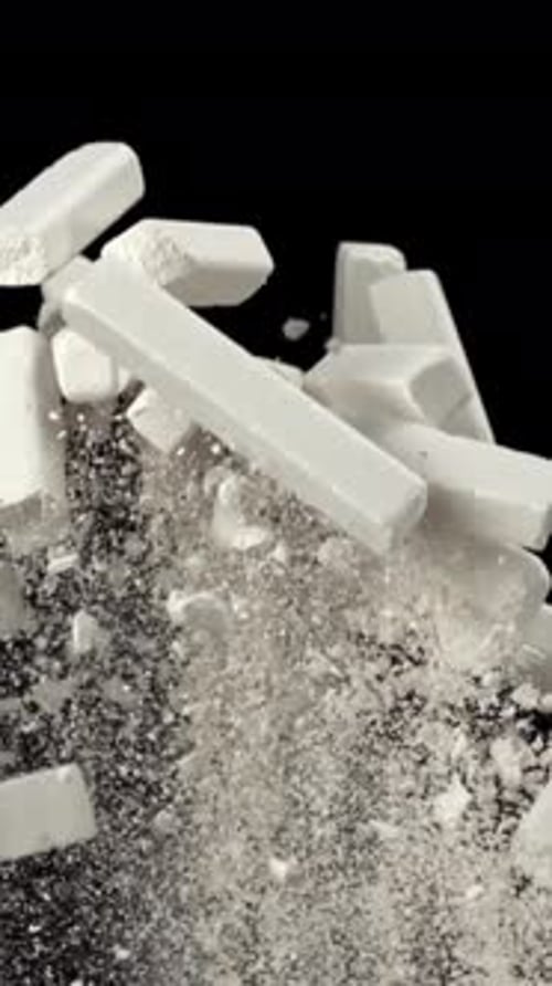 School Chalk Flies Up and Falls Down on a Black Background Filmed on a Highspeed Camera at 1000 Fps