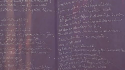 A purple banner with a prayer waving lightly in the wind