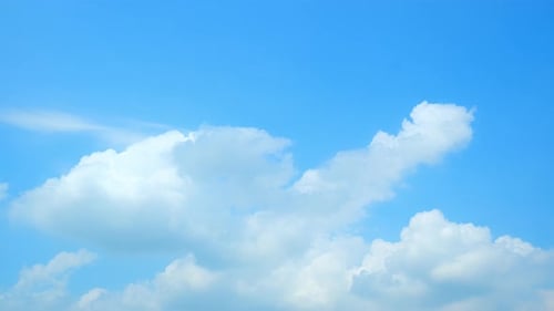 Fluffy clouds moving in the blue sky time-lapse