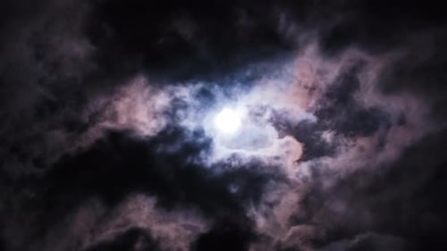 Clouds Passing the Full Moon at Night