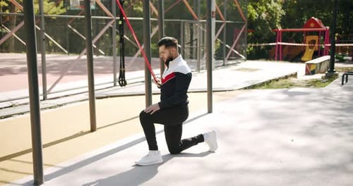 Trainer Male Correcting Fit Does Gym Exercises with Rubber Band