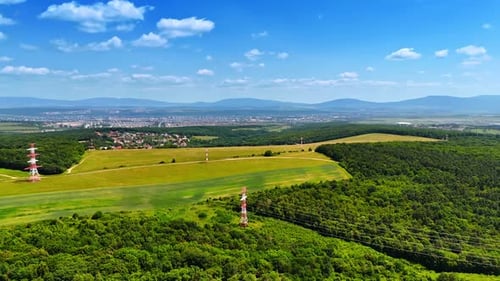 Hügel- und Felderlandschaft. Weite grüne Felder erstrecken sich unter klarem blauem Himmel