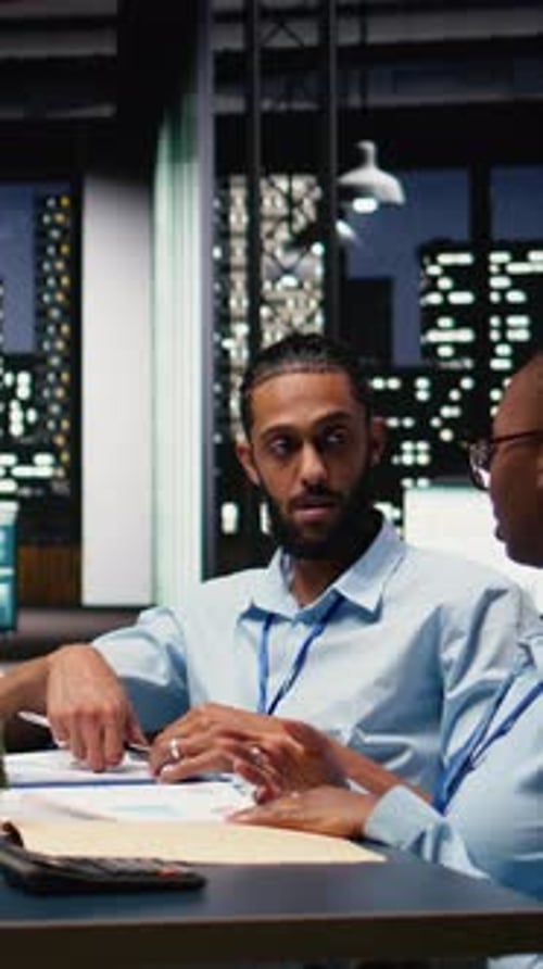 Vertical Video Multiethnic Office Coworkers Reading Emails on Laptop in Boardroom