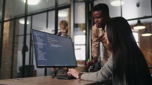 Diverse Ethnic Colleagues In Office Asian Woman And African Man FrontEnd Developers And Testers