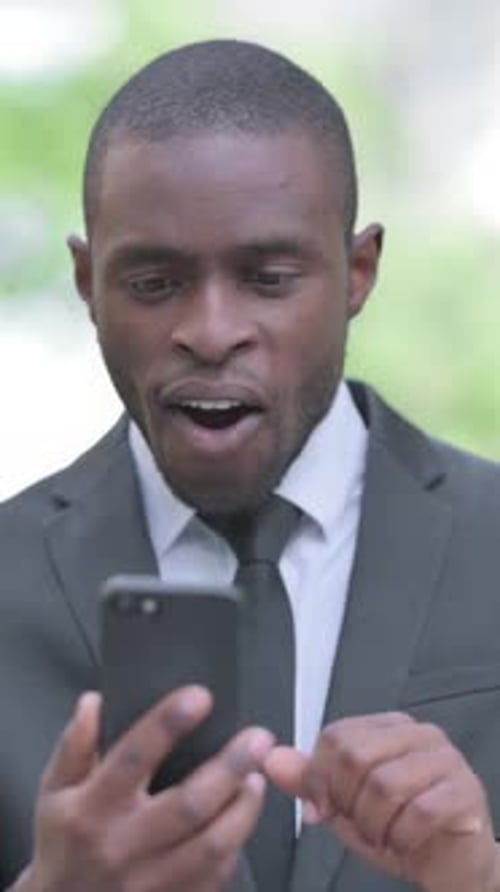Man in Suit Wins While Looking at Phone