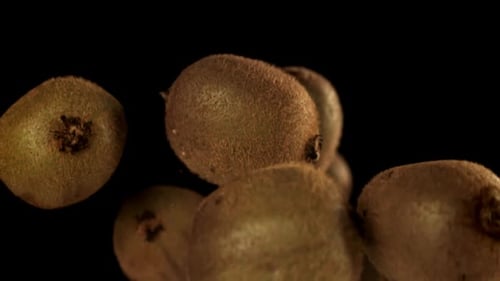 Kiwis Floating in Mid-Air on Black Background