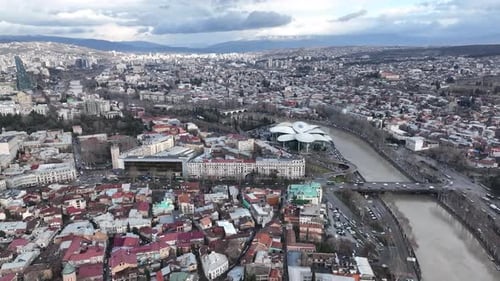 Aerial view of Tbilisi city central park and Bridge of Peace. Beautiful cityscape of old Tbilisi