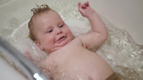 Baby Splashing in Bathtub, Smiling