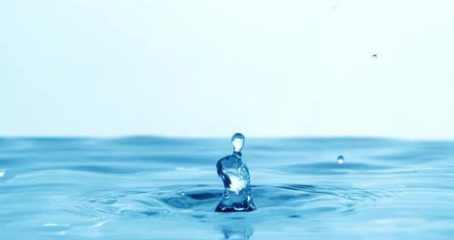 Drop of water falls into a drop of water in a super slow motion. Shot on super slow motion 1600 fps.