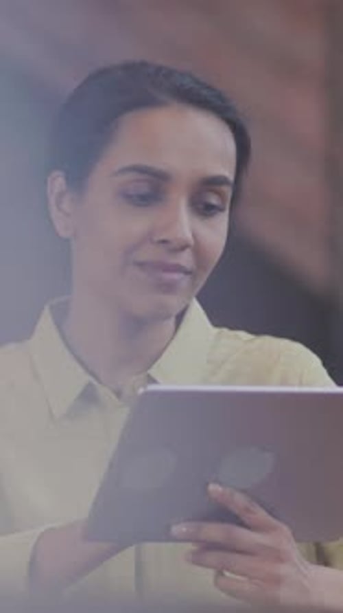 Business Woman working on Digital Tablet Technology in Contemporary Office