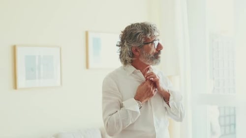 Senior Man Buttons White Shirt Indoors