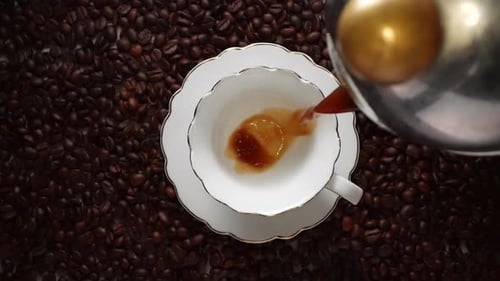 Coffee Being Poured into White Cup