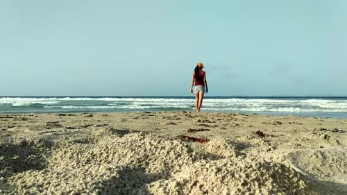 South American Girl Walking Along the Beach on the Coast of Venezuela