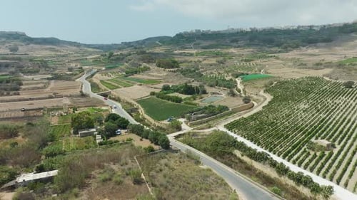 A scenic drone view highlights the farmland and winding country roads, with the natural layout of fi