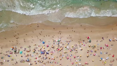Summertime in a public Beach with colorful umbrellas
