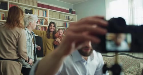 Cinematic shot of happy family members making family photo portrait with photo camera on tripod wi