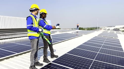 Technician installing solar cell. Installation and maintenance of solar cells on rooftop.