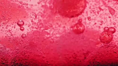 Liquid Bubbles Flowing in Red Tinted Abstract