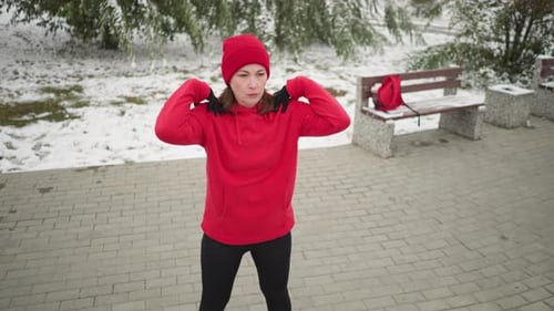 Woman Warming Up in Snowy Winter Park