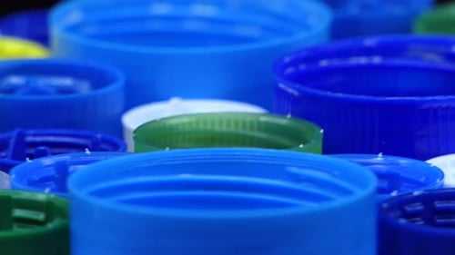 Extrem close-up, used plastic caps of different colors on the back side that turn in a circular way.