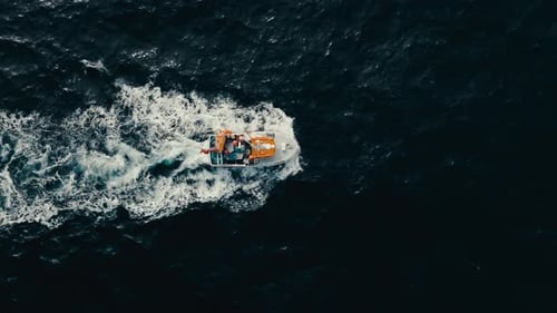 Overhead View Of Fishing Boat Leaving Wake In The Sea. - aerial shot
