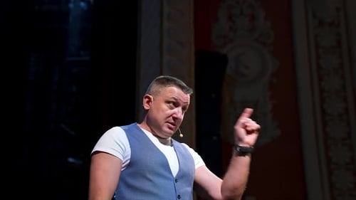 Speaker perform a monologue on stage.