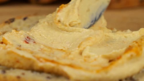 Spreading Tasty Hummus on Healthy Bread Slice