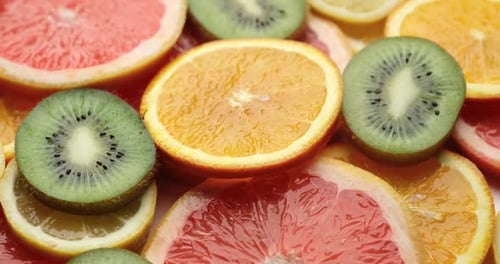 Top Down Background View Made of Fresh Sliced Organic Kiwi Oranges and Lemons Closeup