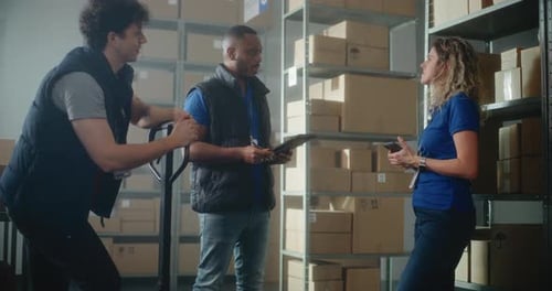 Multiethnic Warehouse Employees African American Logistics Coordinator Gives Instructions