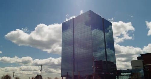 Time Lapse Modern Office Highrise Skyscraper with Clouds in the Reflection