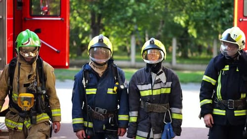 Tired Male and Female Fireguards in Full Equipments Walk After Putting Out the Fire Young Exhausted
