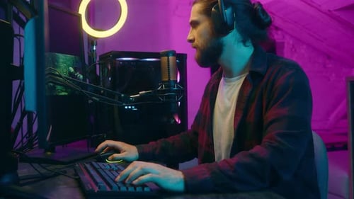 Gamer Playing Video Game in Neon Lit Room