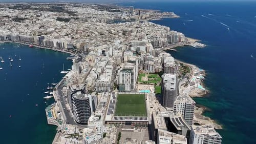 Aerial view of Sliema city. Buildings, apartments, blue sky, Mediterranean sea. Malta island