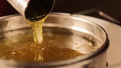 Closeup Shot Of Natural Honey Liquid During Liquid Extracting Process