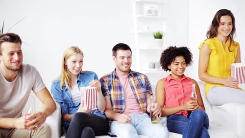 Friendship Leisure People and Entertainment Concept - Happy Friends Eating Popcorn Drinking