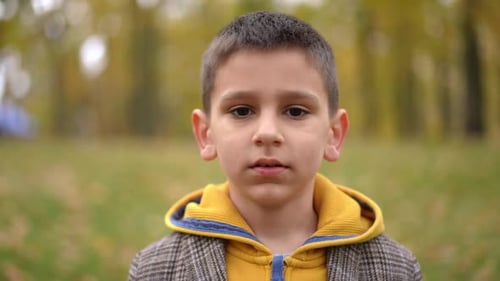 Closeup Front View Confident Boy Looking at Camera Gesturing Air Kiss Smiling Portrait of Charming